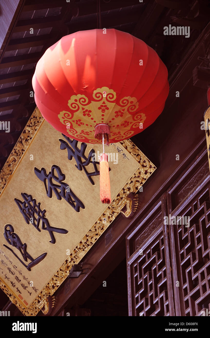 Traditional red lantern hanging from the roof at the Jade Buddha Temple in Shanghai - China Stock Photo