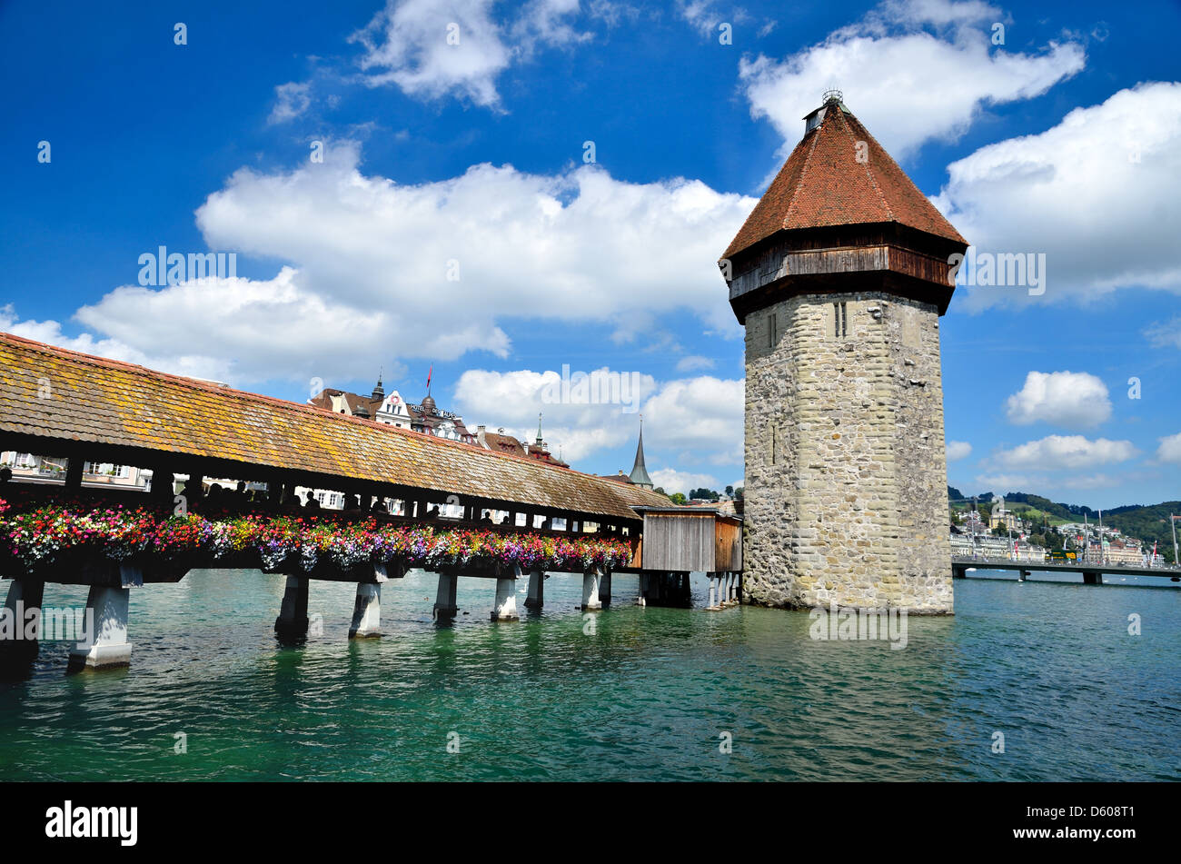 A view of the famous wooden Chapel Bridge of Luzern in Switzerland, with the tower in foreground Stock Photo