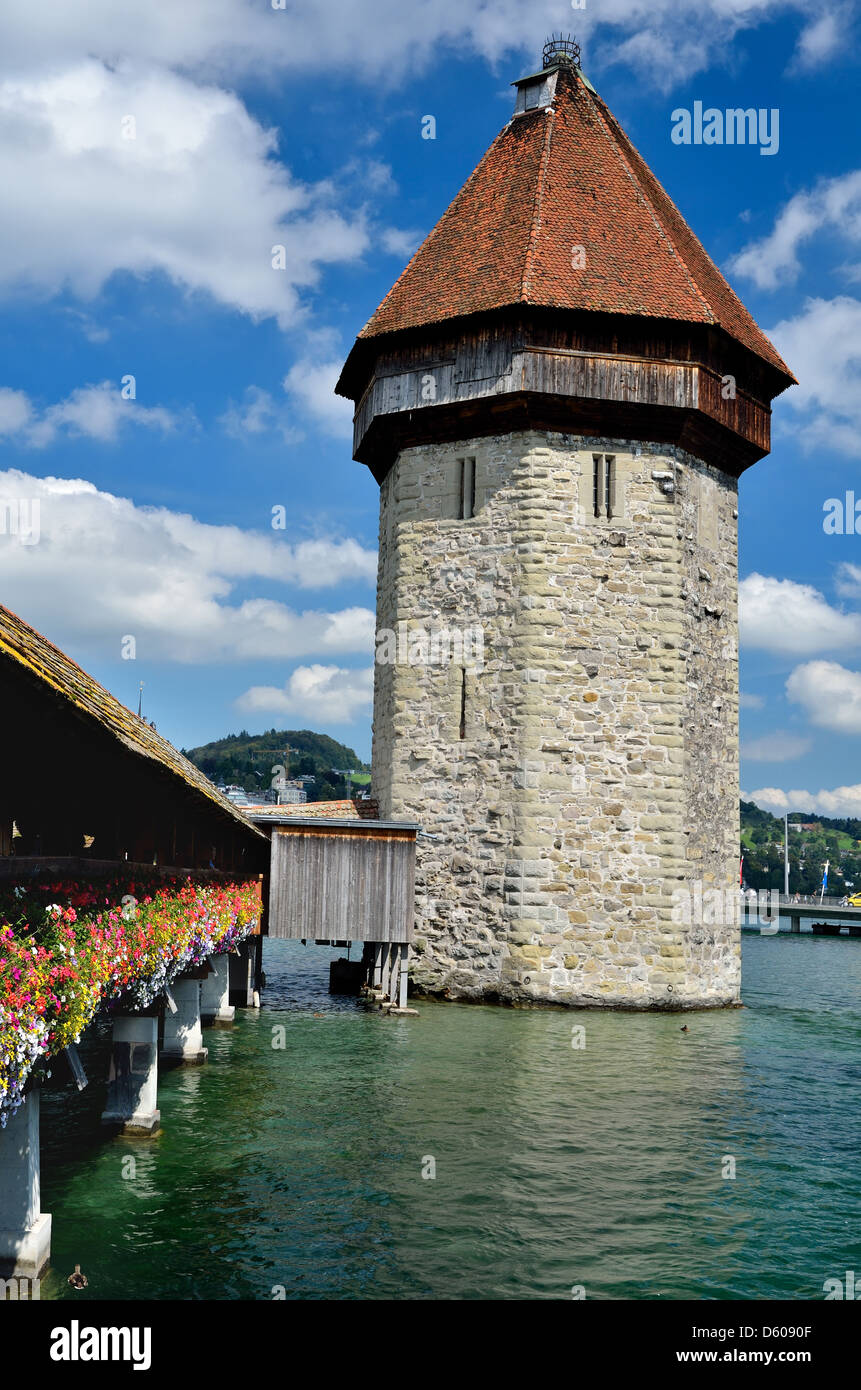 A view of the famous wooden Chapel Bridge of Luzern in Switzerland, with the tower in foreground Stock Photo