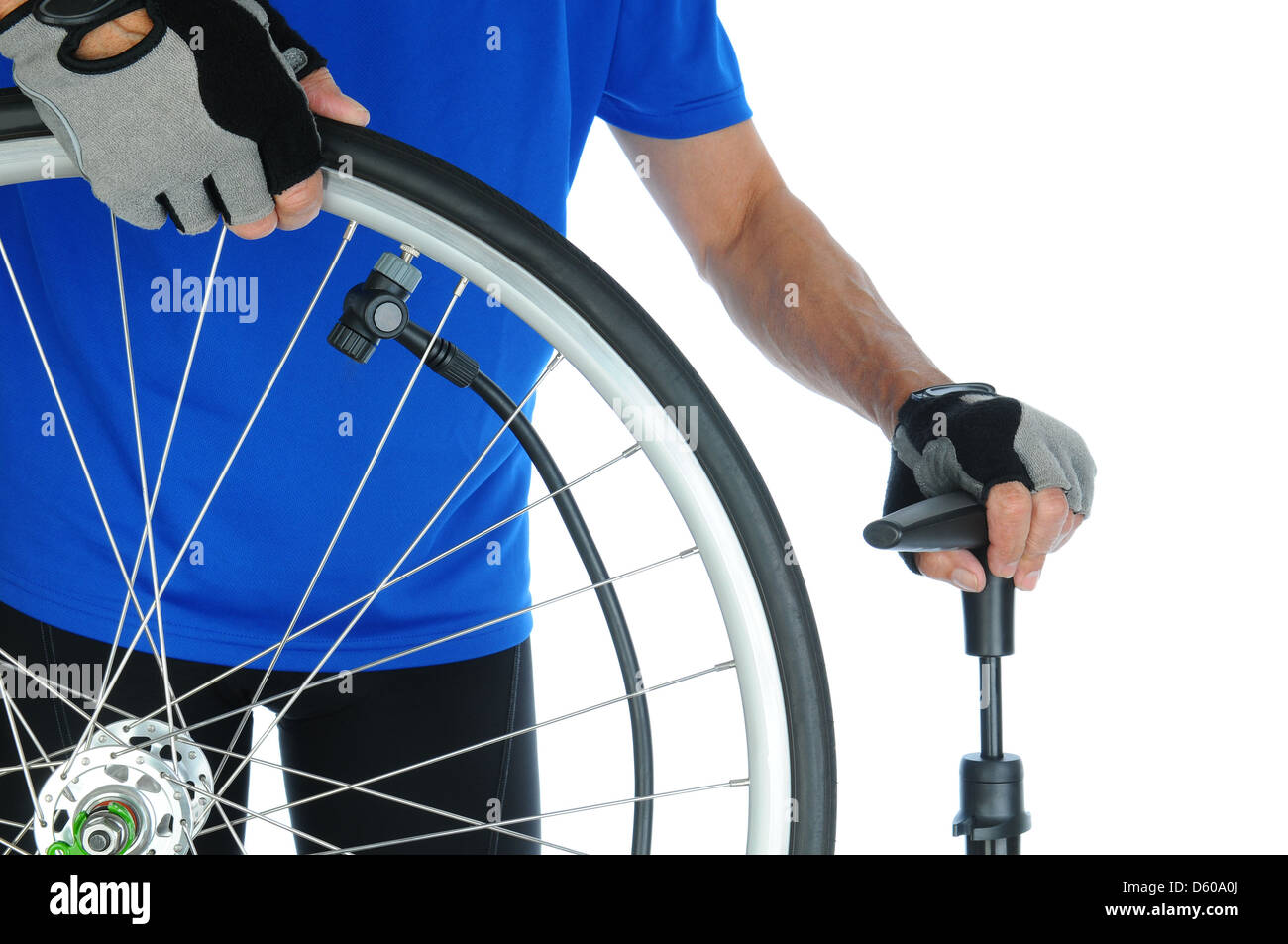 Closeup of a cyclist pumping up a bicycle tire. Man is unrecognizable and standing behind the wheel. Stock Photo