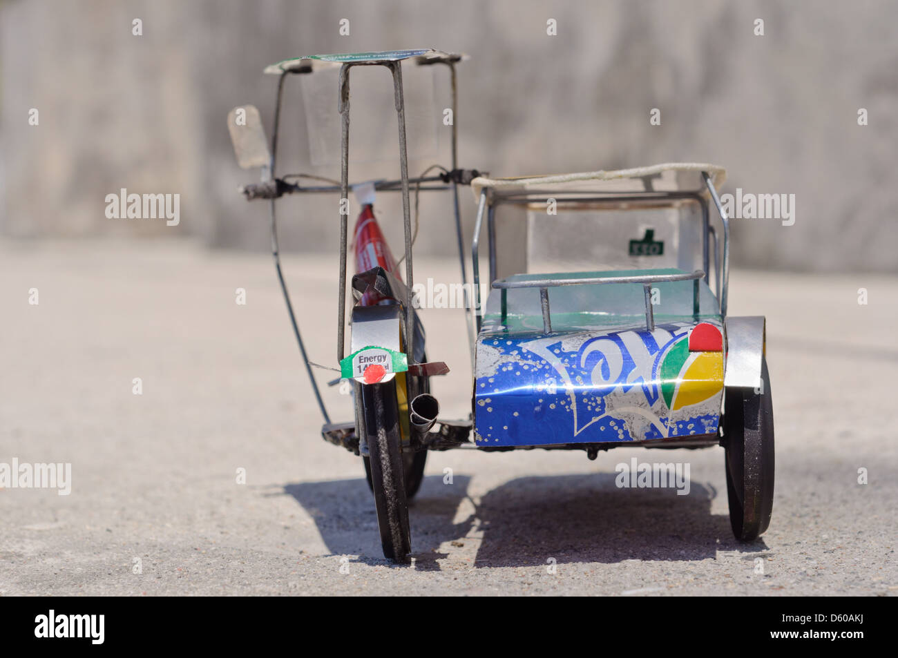 Toy model of a Philippine tricycle, motorcycle with sidecar, made of used Coke, Sprite, Schweppes beverage cans Stock Photo