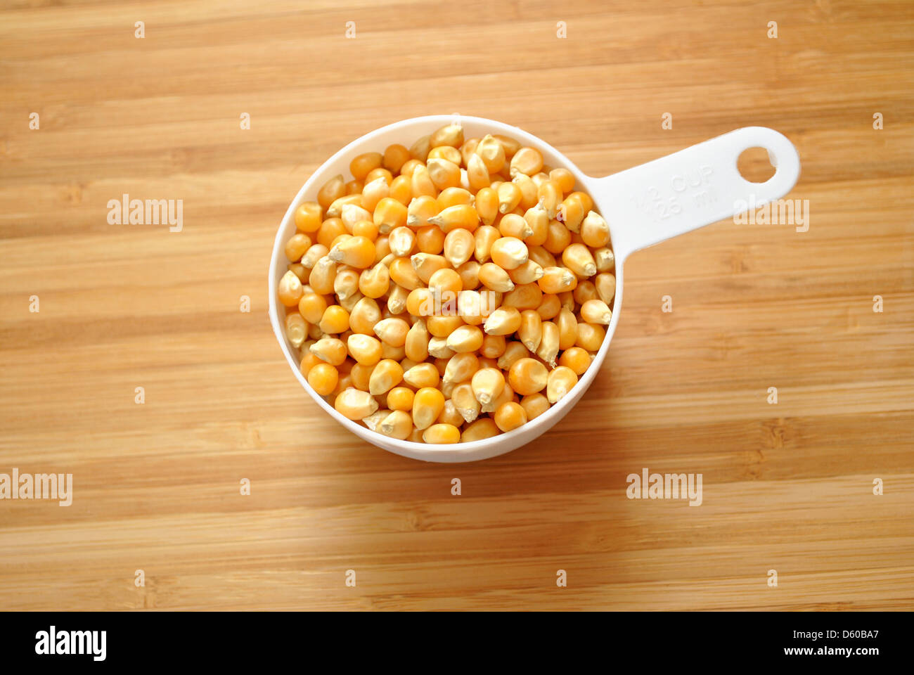 Yellow Popcorn Kernels in a White Measuring Cup Stock Photo Alamy