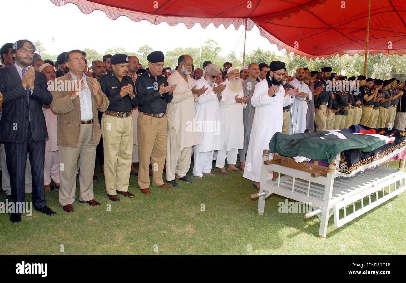 Sindh Police Inspector General (IG), Shahid Nadeem Baloch and other senior police officials offer Dua for Shaheed Inspector Agha Asadullah, who was gunned down by unidentified persons in Saddar locality last night, during funeral prayer at Police Garden Headquarter in Karachi on Wednesday, April 10, 2013. Stock Photo
