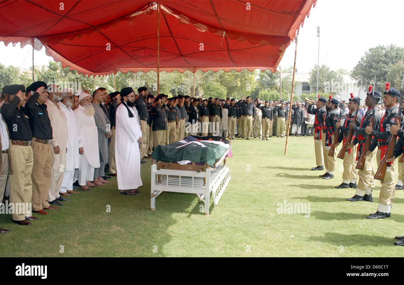 KARACHI, PAKISTAN, APR 10: Sindh Police Inspector General (IG), Shahid Nadeem Baloch  and other senior police officials present guard of honour to Shaheed Inspector Agha Asadullah,  who was gunned down by unidentified persons in Saddar locality last night, during funeral  prayer at Police Garden Headquarter in Karachi on Wednesday, April 10, 2013. (PPI Images). Stock Photo