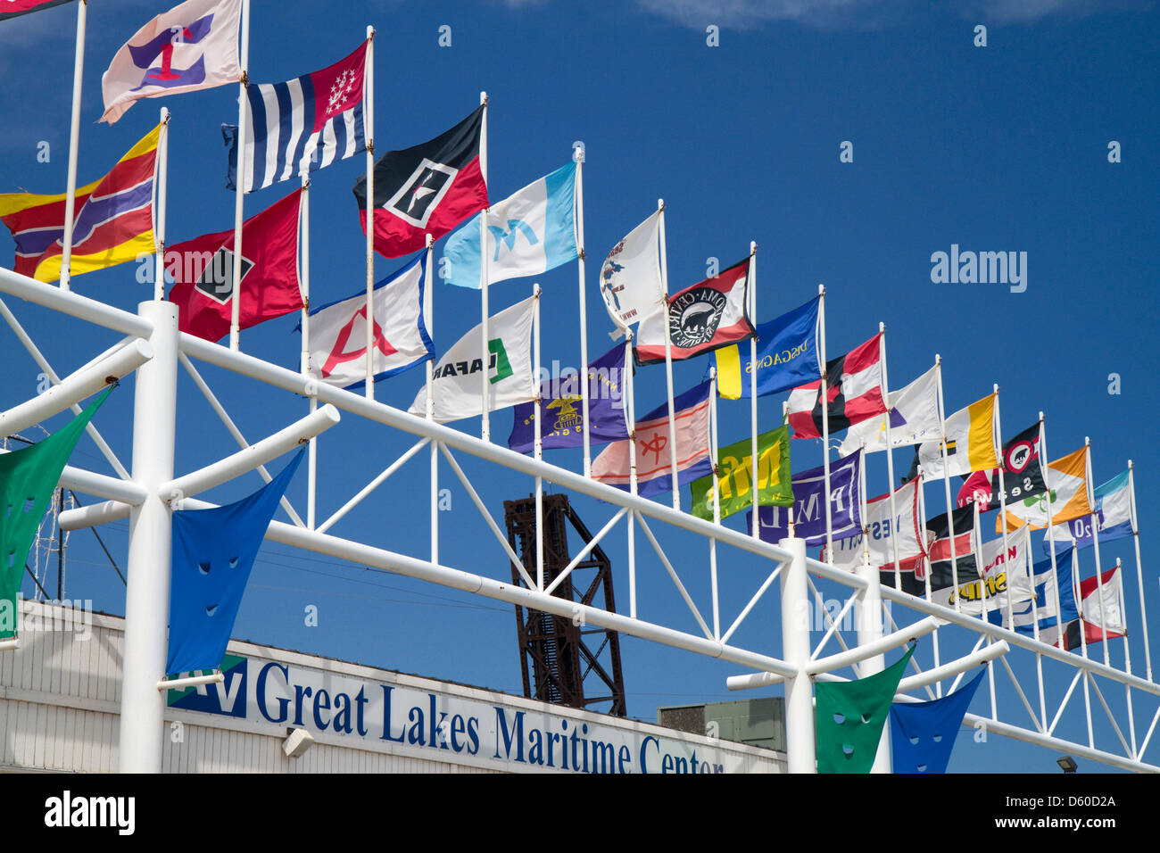 Shipping company flags in front of the Great Lakes Maritime Center along the St. Clair river at Port Huron, Michigan, USA. Stock Photo