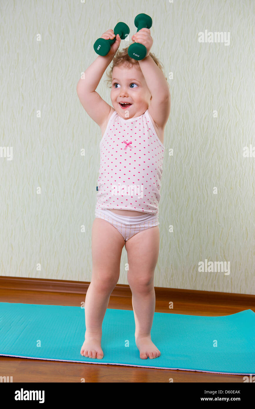 Fitness workout with dumbbells for cute little girl Stock Photo ...