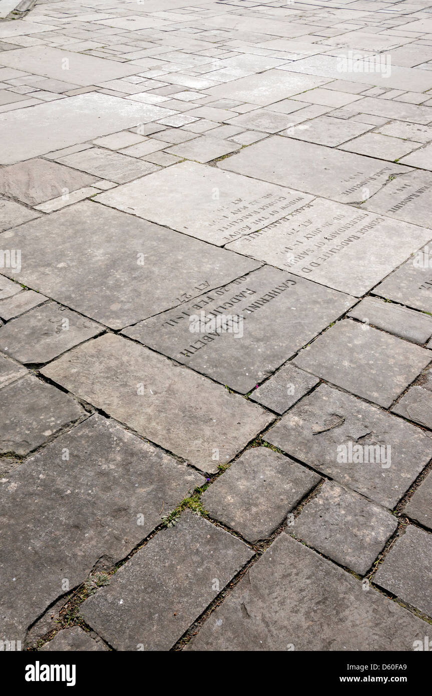 Paved church courtyard incorporating old memorial stones Stock Photo
