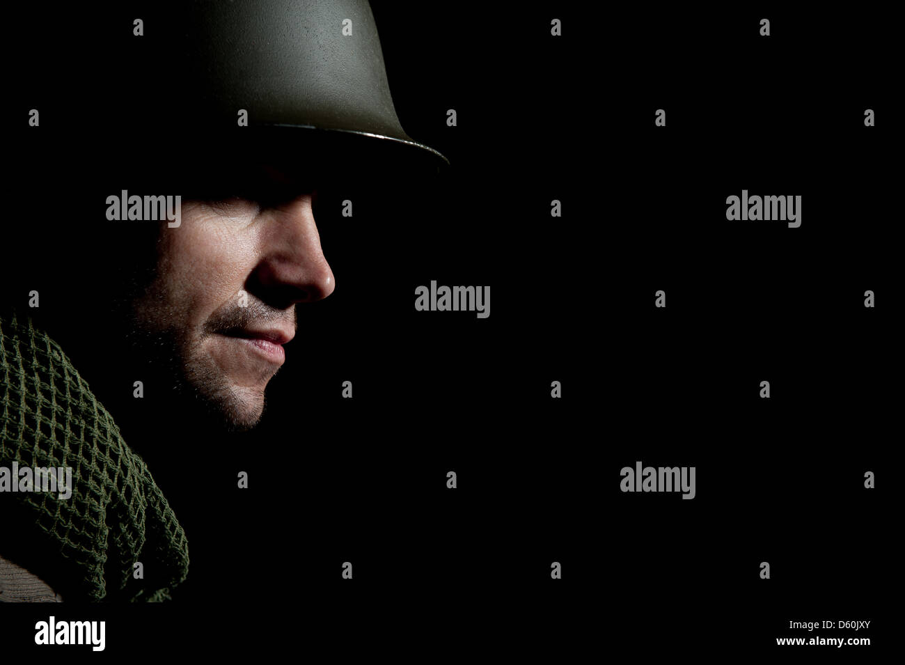 Portrait in profile of a WW2 U.S. soldier against a black background ...