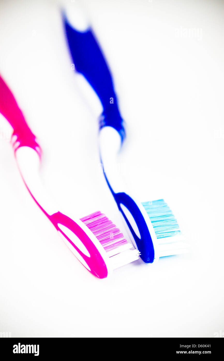 Pink and blue his and hers toothbrushes Stock Photo