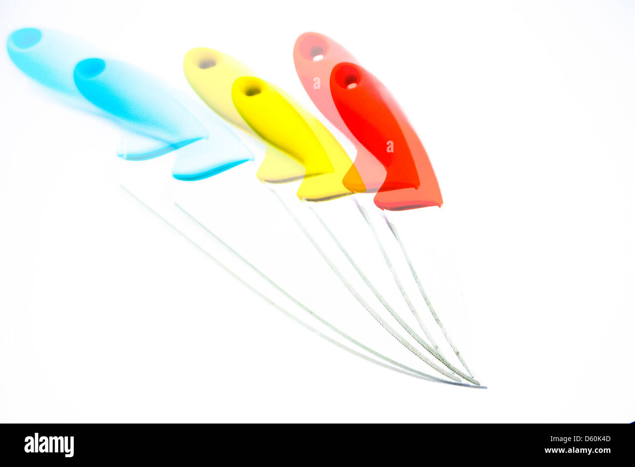 Three kitchen knives with colourful plastic handles Stock Photo