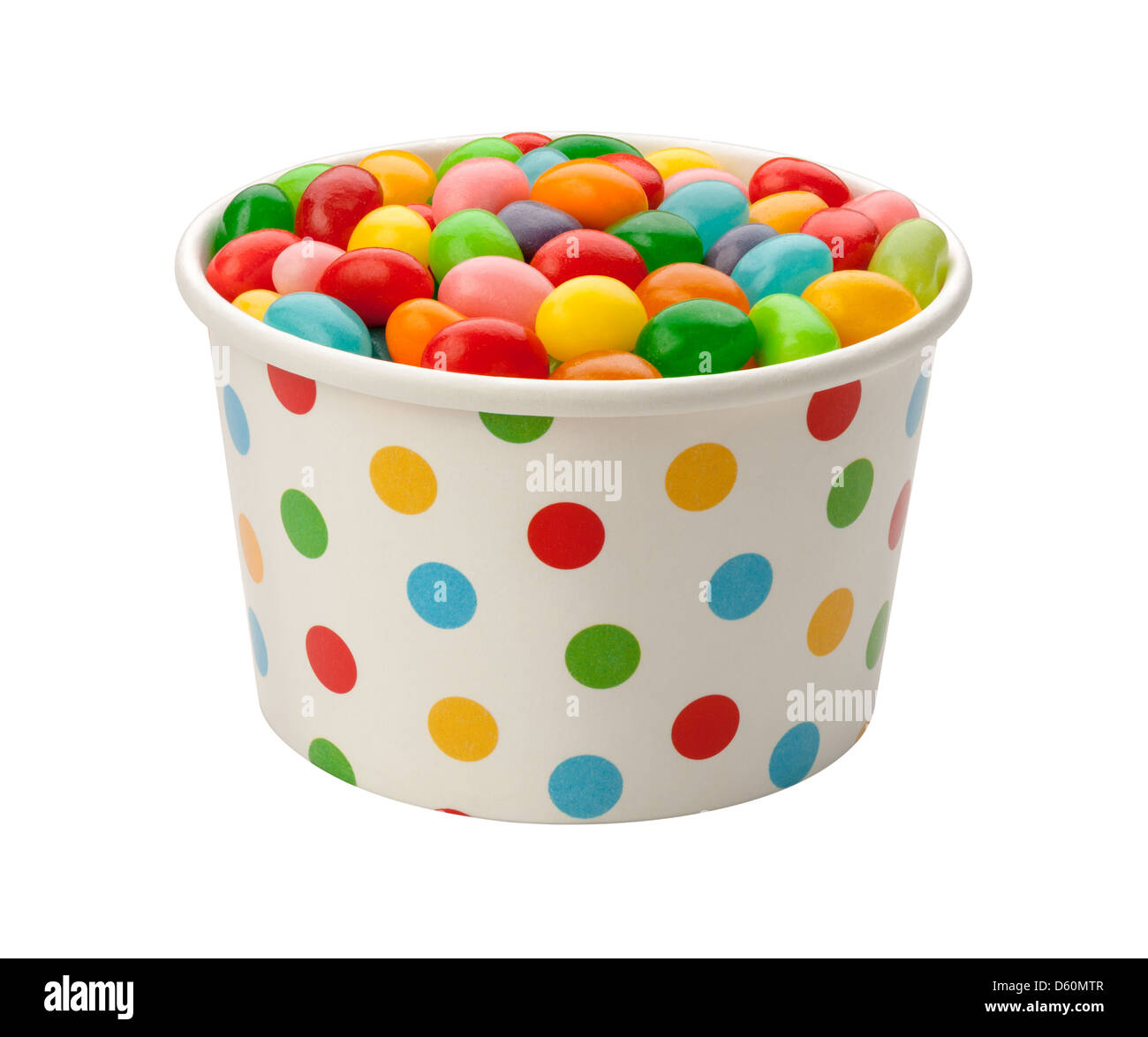 Jellybeans in a paper cup, isolated on white. Stock Photo