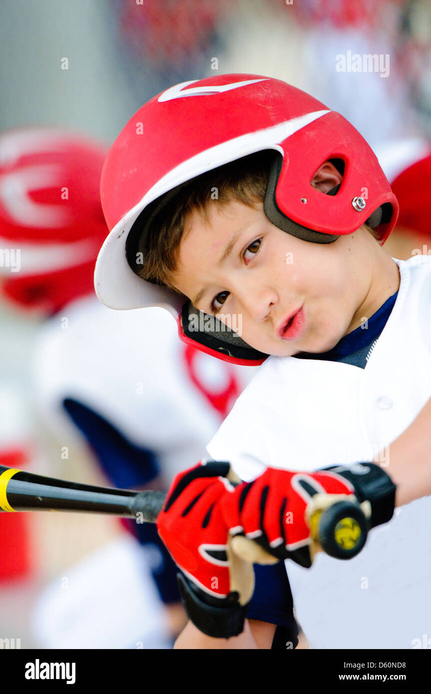 Little league baseball player swinging the bat up close. Stock Photo