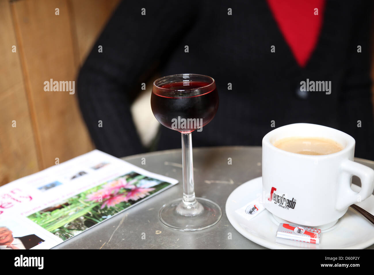 cafe table with glass of French Pineau - similar to cherry  and cafe au lait Stock Photo