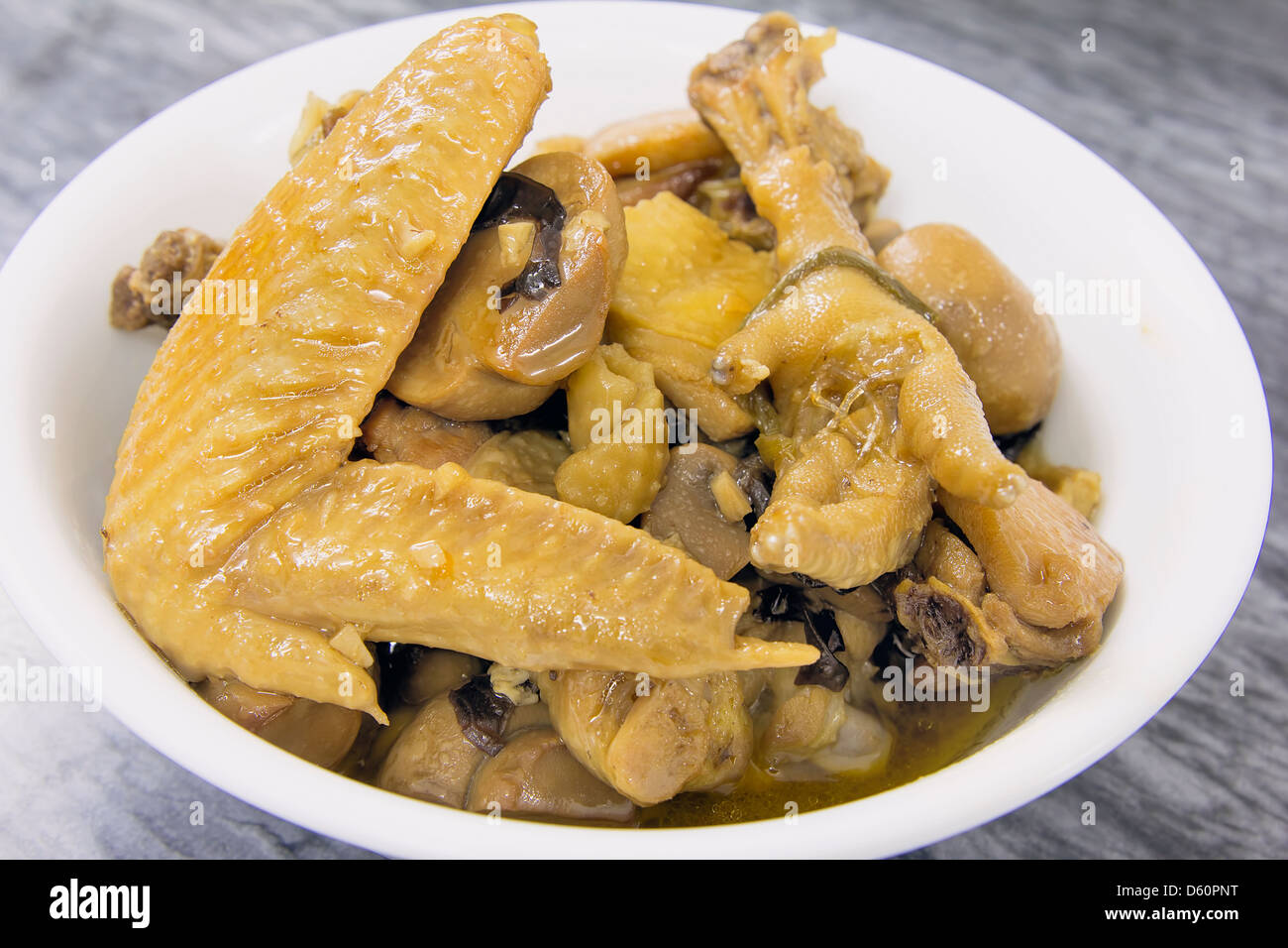 Chinese Soy Sauce Chicken Wings Feet with Garlic Button Mushrooms and Black Fungus Dish Stock Photo