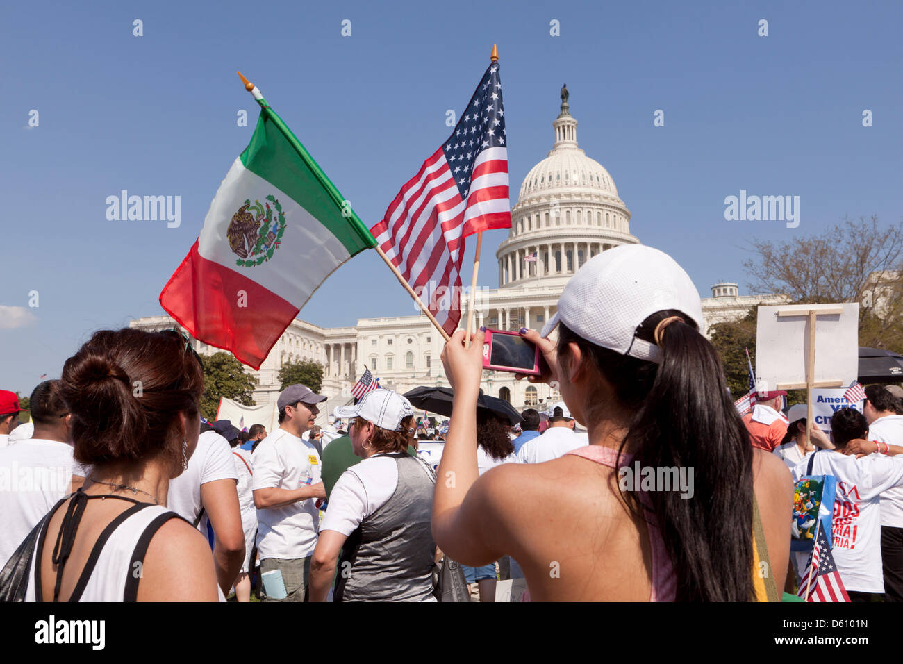 Young woman waving Mexican and American flags in front of the US Capitol, at an immigration reform rally - Washington, DC USA Stock Photo