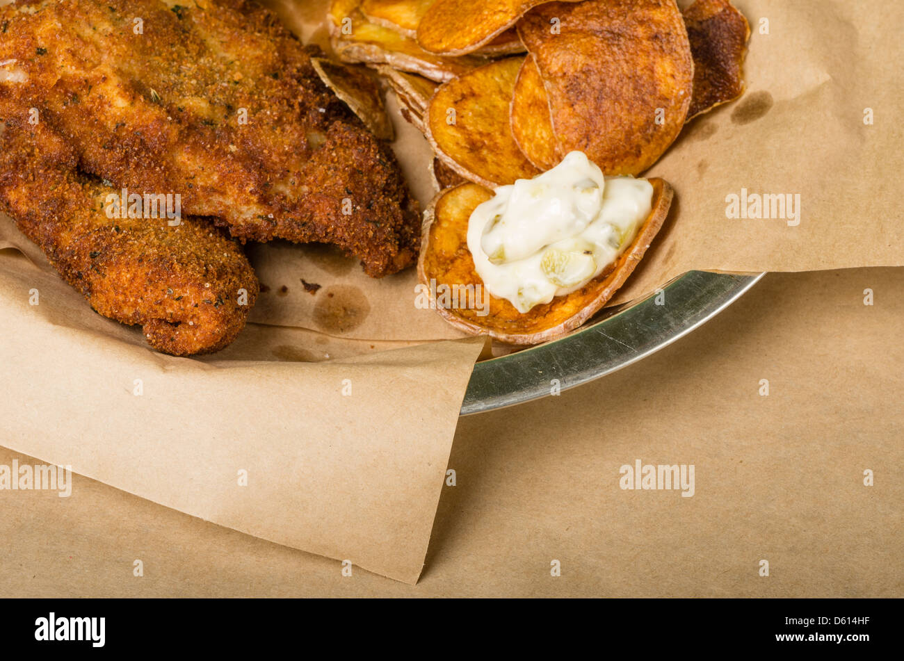 Fried fish and chips with lemon on a wooden table Stock Photo