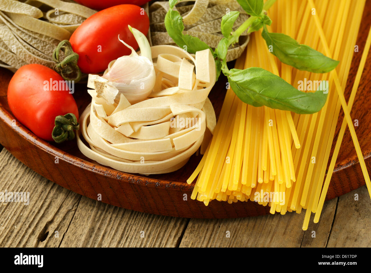 Various types of pasta (spaghetti, fettuccini, penne) and tomato Stock ...