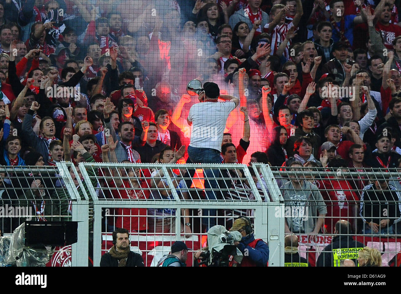 Munich's fans light flares at the stands during the German Bundesliga