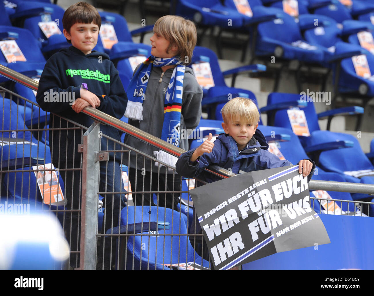 Young fans of Hamburger SV hold a poster reading 'We for You - You for ...