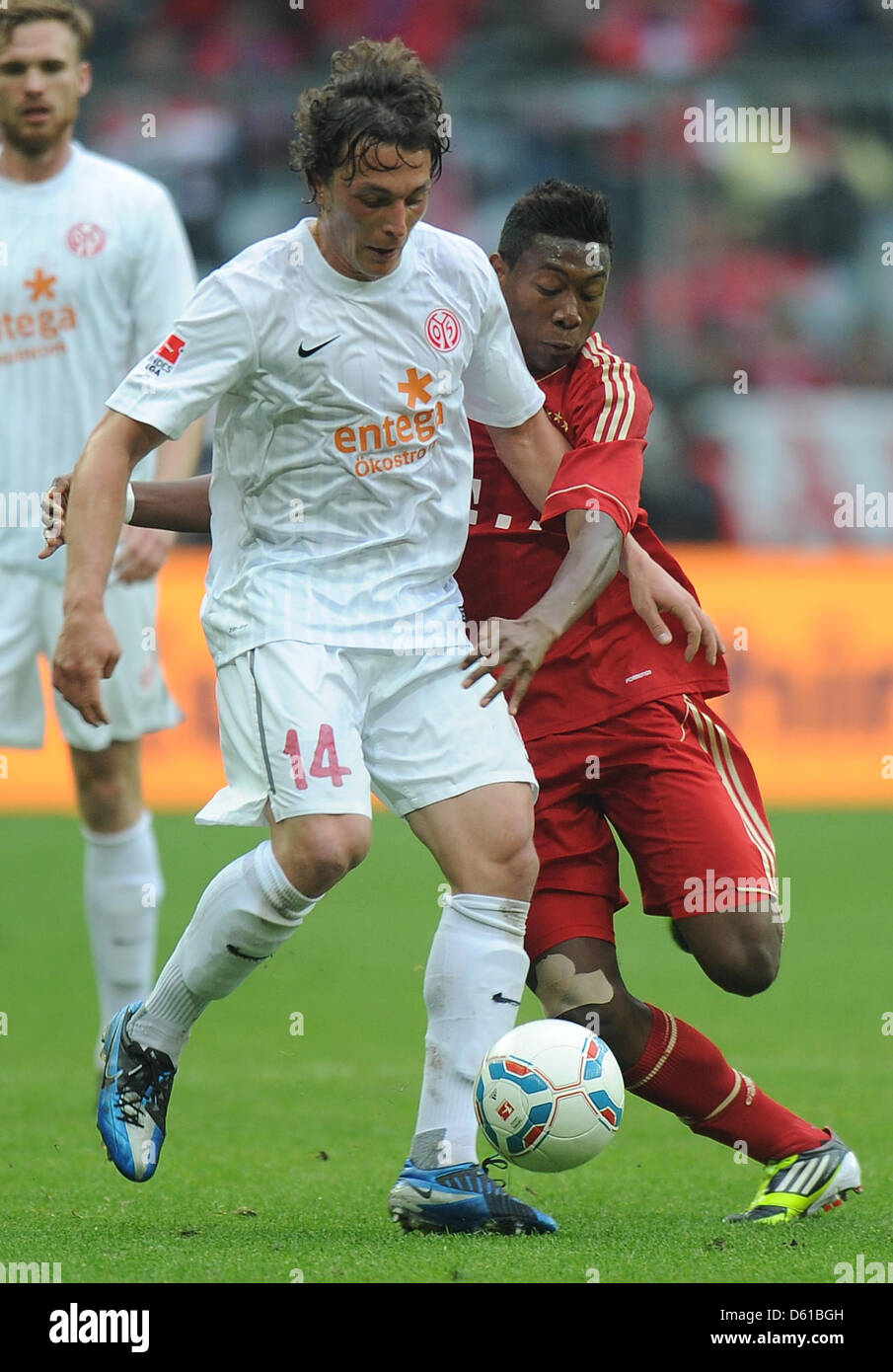 FC Bayern Munich's David Alaba (R) vies for the ball with Mainz's Julian Baumgartlinger during the German Budnesliga soccer match between FC Bayern Munich and FSV Mainz 05 at the Allianz Arena in Munich, Germany, 14 April 2012. Photo: Marc Mueller Stock Photo