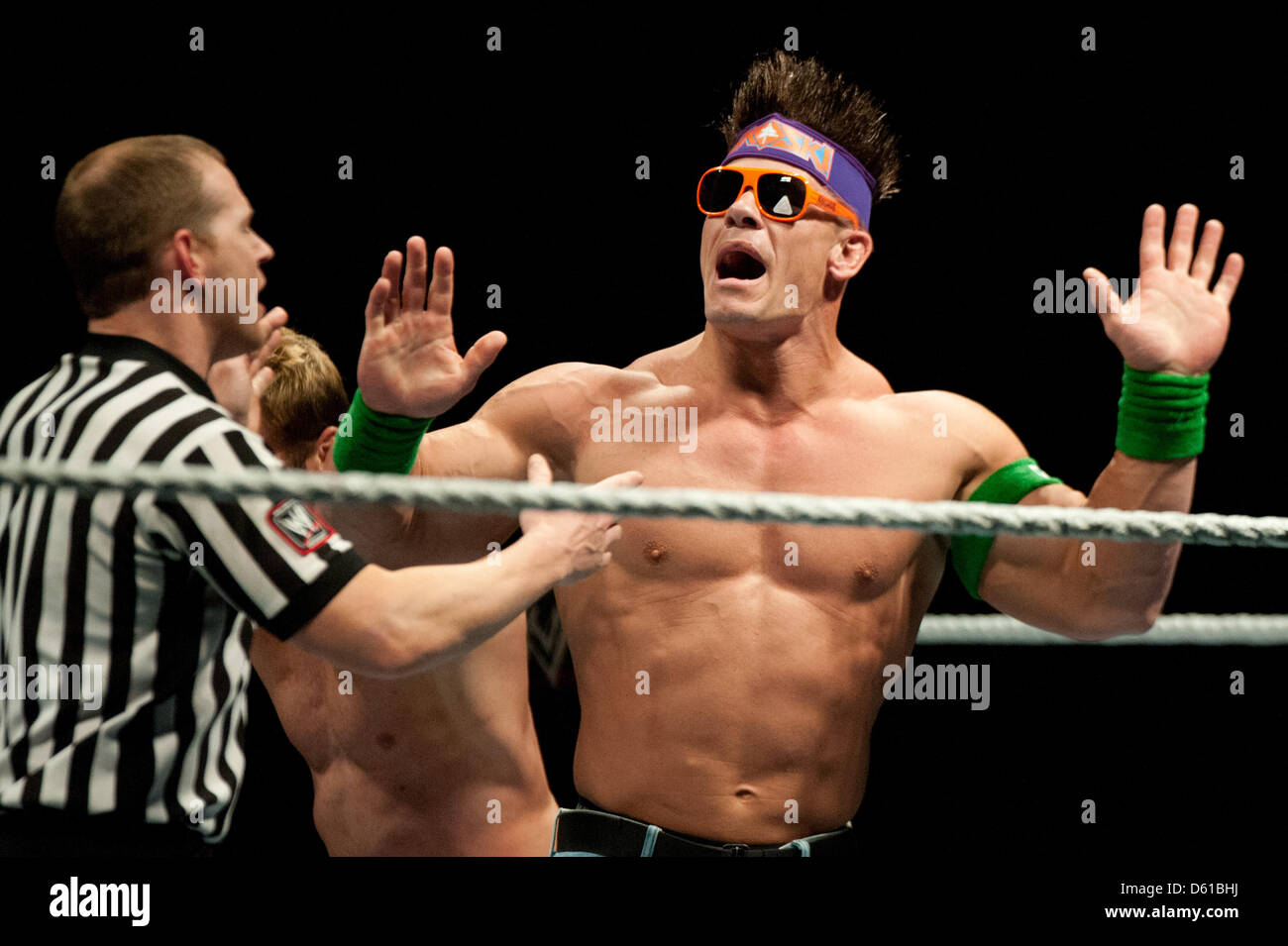 US-wrestler John Cena (R) gestures during an argument with the referee during the RAW WrestleMania Revenge Tour at the o2 World canue in Berlin, Germany, 14 April 2012. The WWE (World Wrestling Entertainment) celebrates its 20th German anniversary this April. The first show in Germany was staged in Kiel, Germany, in April 1992. Photo: Sebastian Kahnert Stock Photo