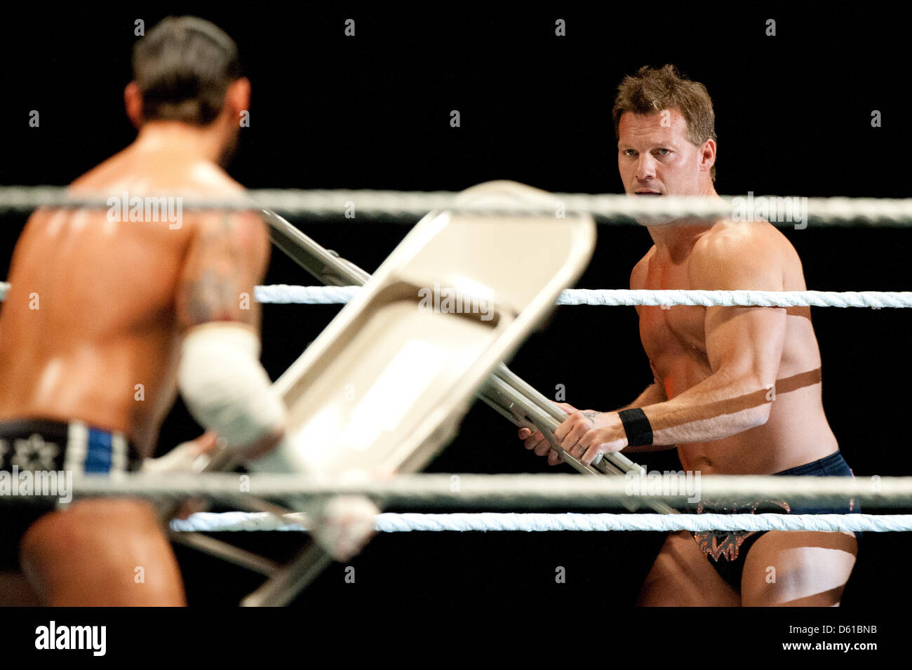 US-wrestler CM Punk (L) and Canadian-wrestler  Chris Jericho threaten each other with folding chairs during a fight at the RAW WrestleMania Revenge Tour at the o2 World canue in Berlin, Germany, 14 April 2012. The WWE (World Wrestling Entertainment) celebrates its 20th German anniversary this April. The first show in Germany was staged in Kiel, Germany, in April 1992. Photo: Sebast Stock Photo