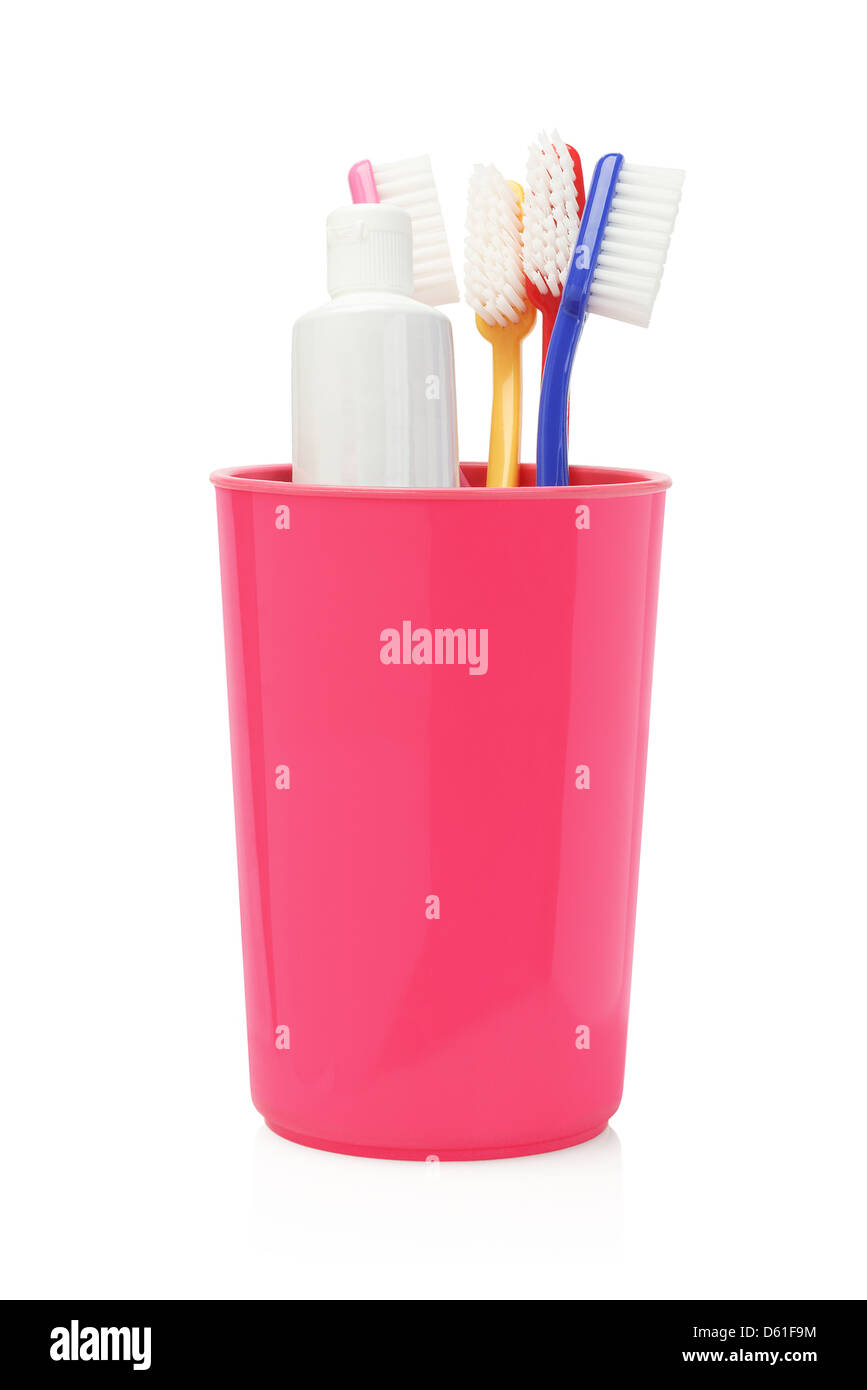 Toothbrushes and Toothpaste In Plastic Container on white Background