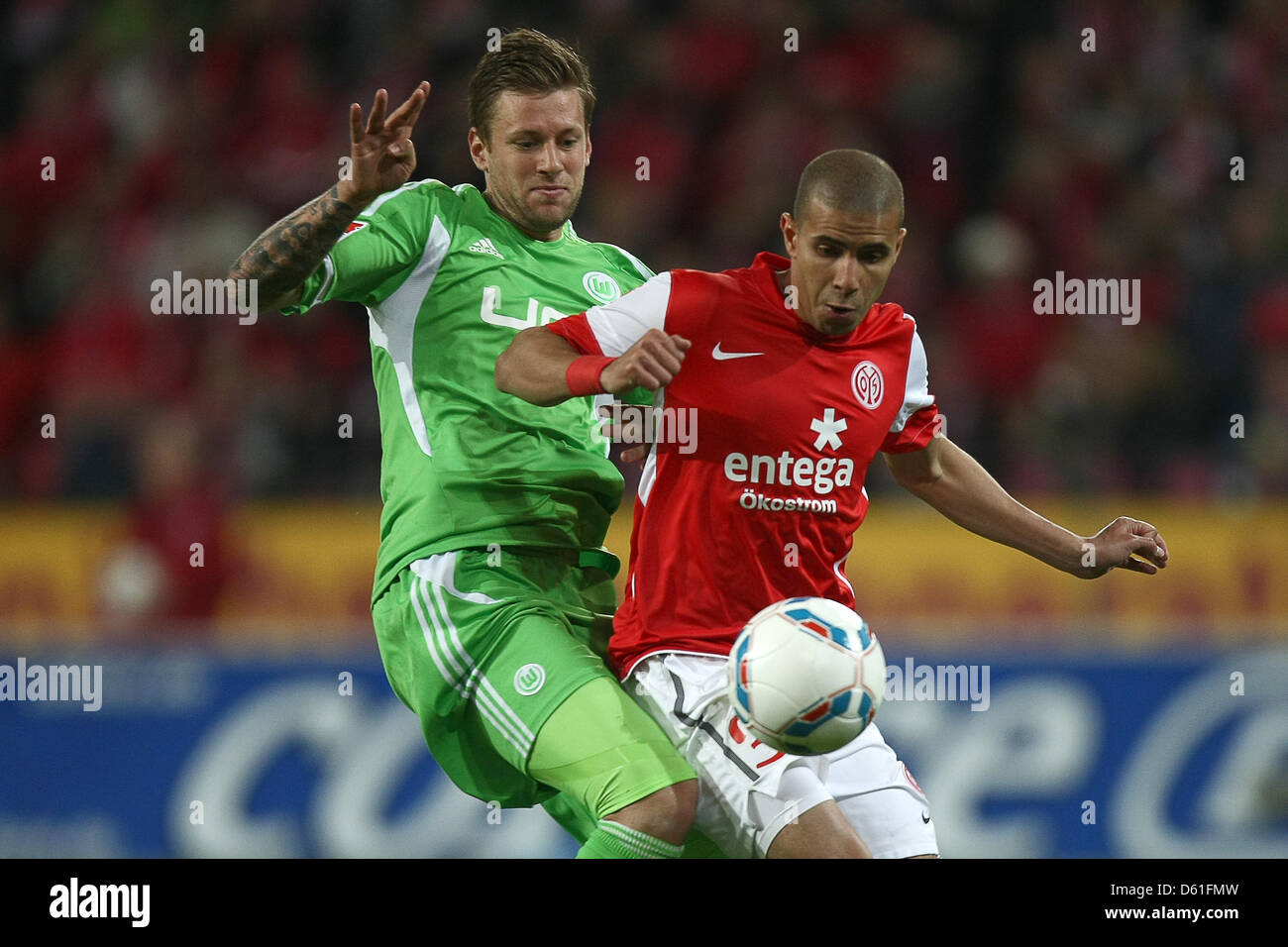 Mainz's Mohamed Zidan and Wolfsburg's Marco Russ (L) vie for the ball during the Bundesliga soccer match between FSV Mainz 05 and VfL Wolfsburg at the Coface Arena in Mainz, Germany, 20 April 2012. Photo: Fredrik Von Erichsen Stock Photo