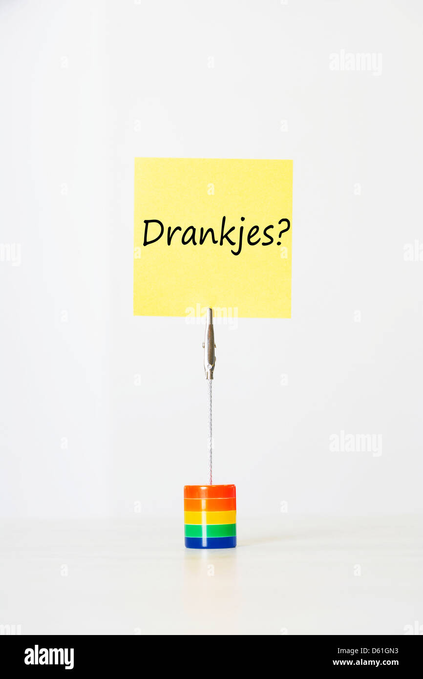 Sticky notepaper with Dutch text meaning 'Drankjes?' (Drinks) clipped  multicolored card holder Stock Photo