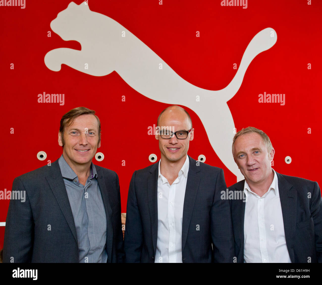 Franz Koch (C), executive director of the sportswear manufacturer Puma,  Jochen Zeitz (L), chairman of the supervisory board of Puma, and  Francois-Henri Pinault, deputy chairman of the supervisory board of Puma,  stand