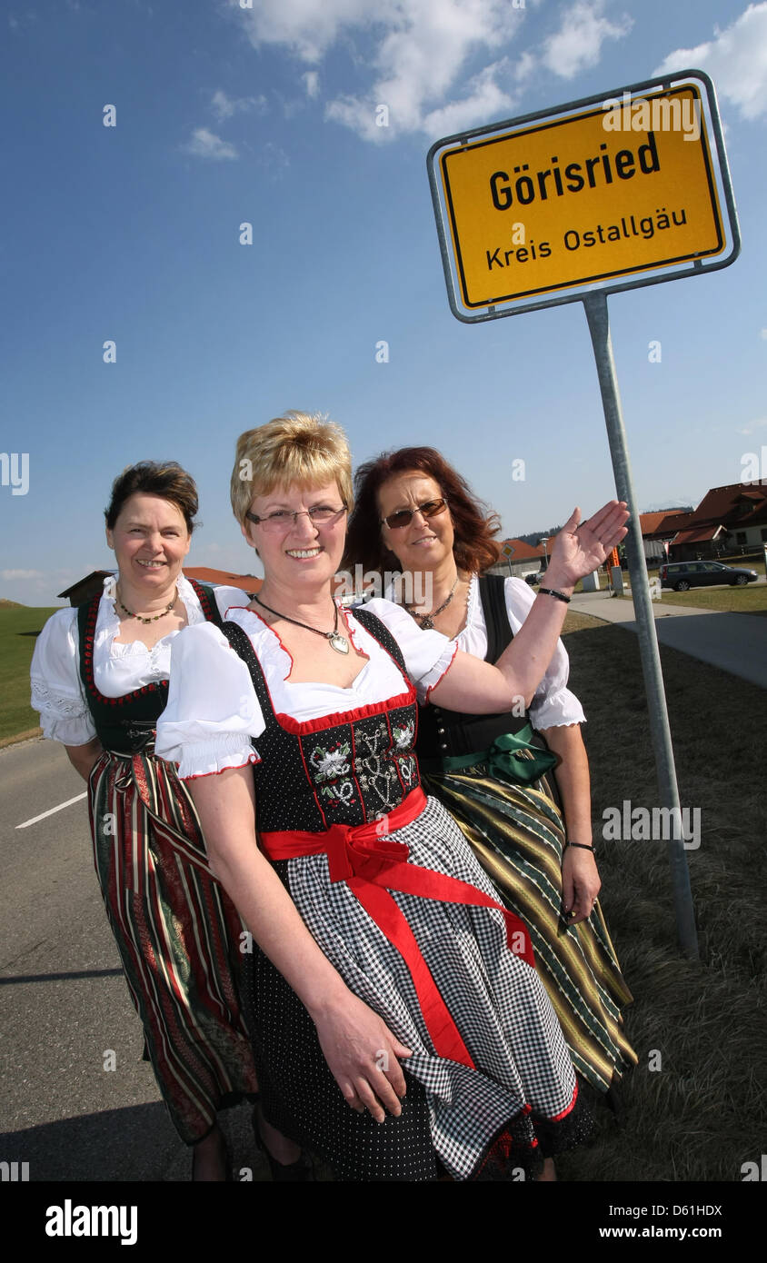 First mayor of Goerisried Thea Barnsteiner (C), second mayor Petra Muder (R) and third mayor Karin Knuesli (R) stand in front of the town limit sign in Goerisried, Germany, 23 March 2012. There are three mayors in the village of 1,300 resident in the Allgaeu. Photo: Karl-Josef Hildenbrand Stock Photo