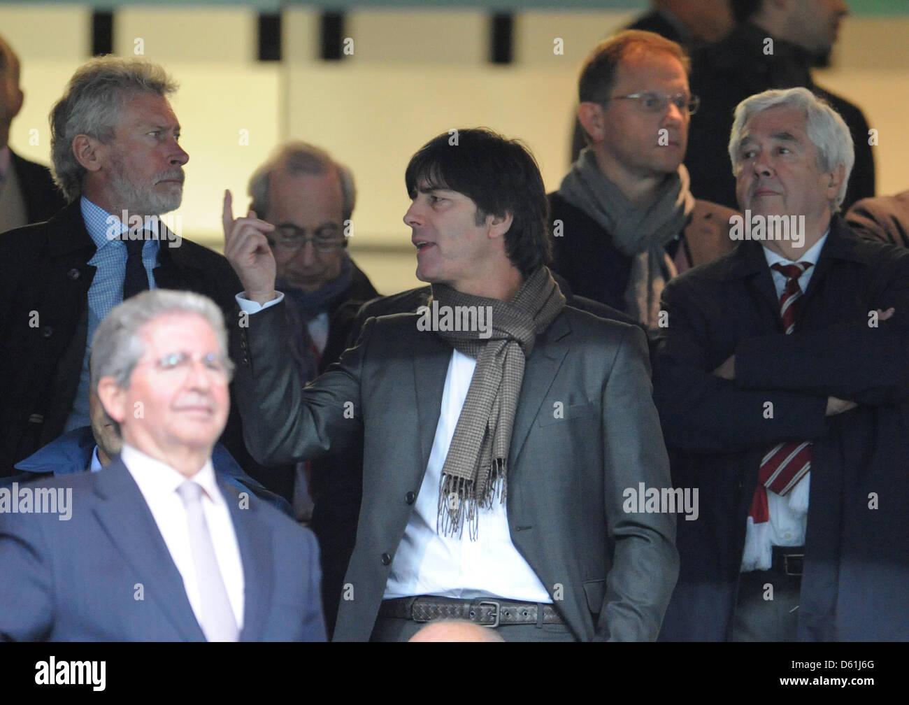 Joachim Loew (C), head coach of the german national football team, talks to former soccer player Paul Breitner (L) on the stand during the Champions League semi final second leg soccer match between Real Madrid and FC Bayern Munich at the Santiago Bernabeu stadium in Madrid, Spain, 25 April 2012. Photo: Andreas Gebert dpa  +++(c) dpa - Bildfunk+++ Stock Photo