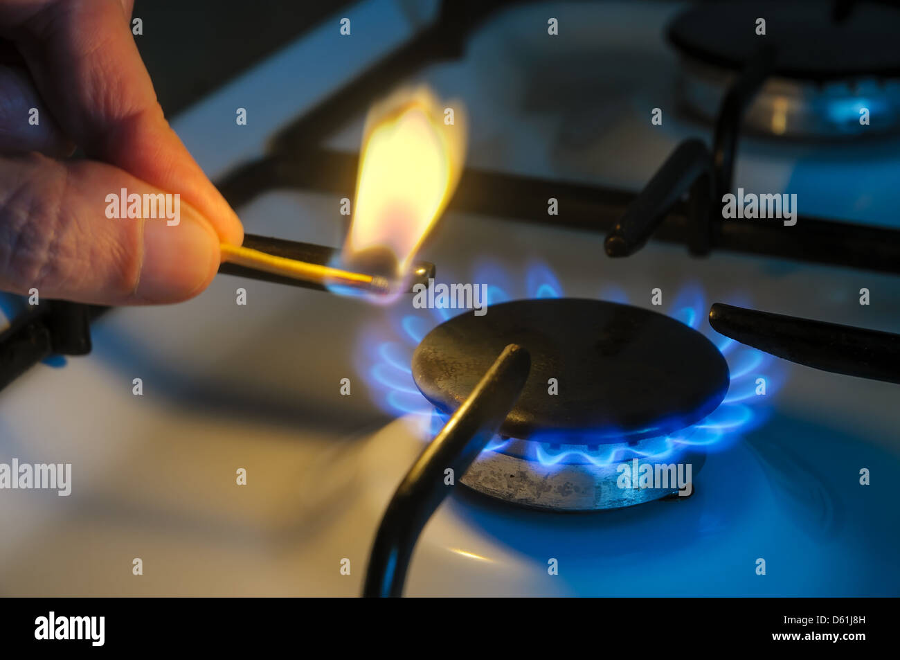 A man lighting the gasstove with a match Stock Photo Alamy