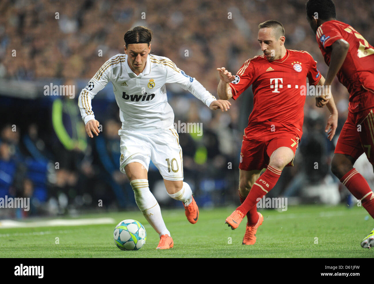 Munich's Franck Ribery and Madrid's Mesut Ozil vie for the ball during the Champions League semi final second leg soccer match between Real Madrid and FC Bayern Munich at the Santiago Bernabeu stadium in Madrid, Spain, 25 April 2012. Photo: Andreas Gebert Stock Photo
