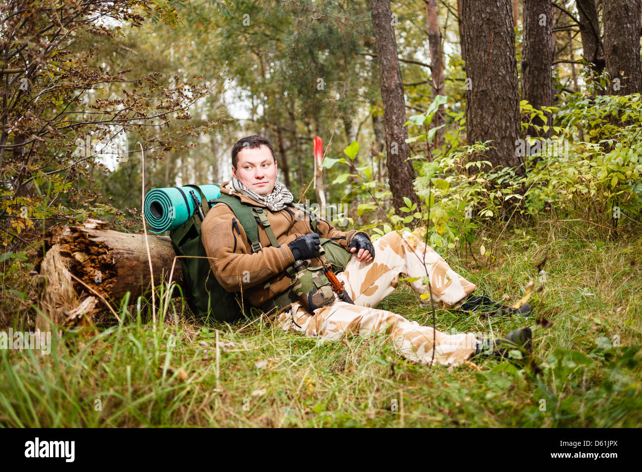 Soldier relaxing in a forest. Stock Photo