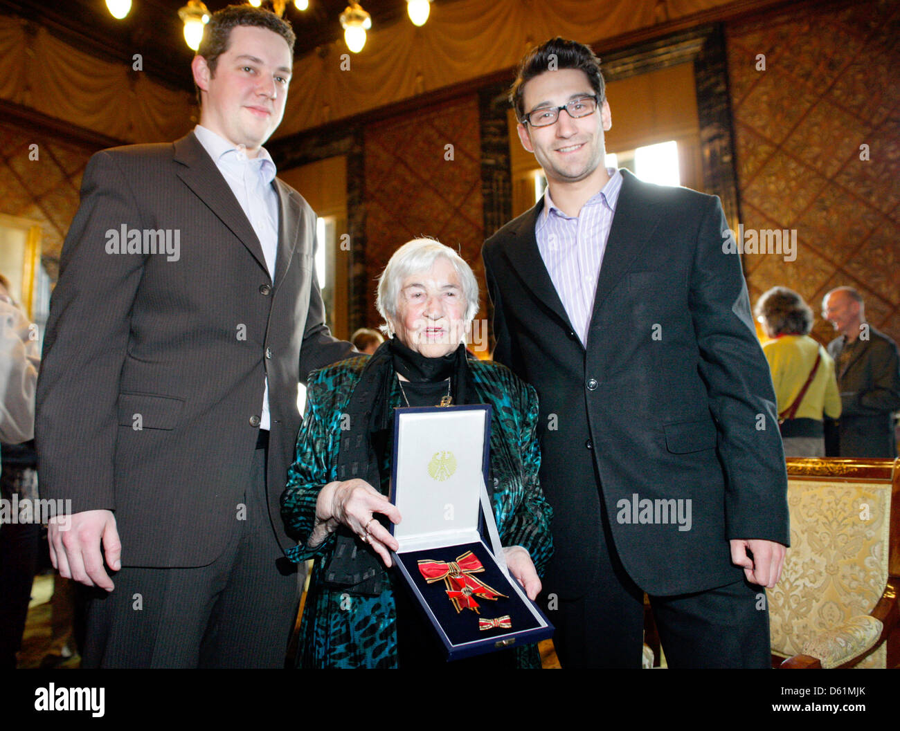 Esther Bejarano is pictured with her Great Federal Cross of Merit and her grown-up grandsons Jonathan Bejarano (L) and Anton Saefkow at the city hall in Hamburg, Germany, 26 April 2012. Mayor of Hamburg Olaf Scholz awarded her the Great Federal Cross of Merit. Bejarano is one of the last survivors of the girls' orchestra of Auschwitz. Photo: DANIEL BOCKWOLDT Stock Photo