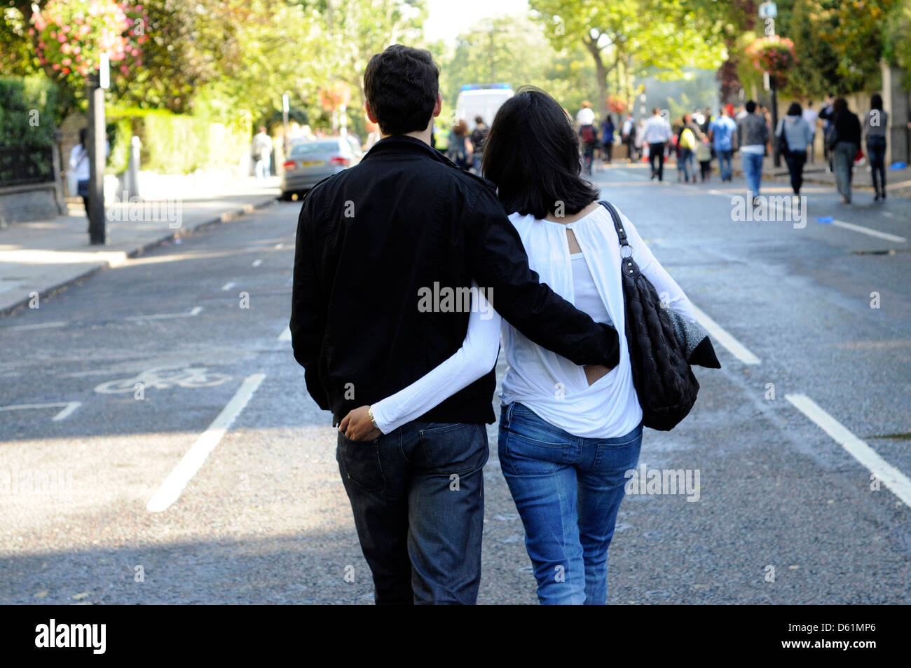 A couple walking with their arms around each other. Stock Photo