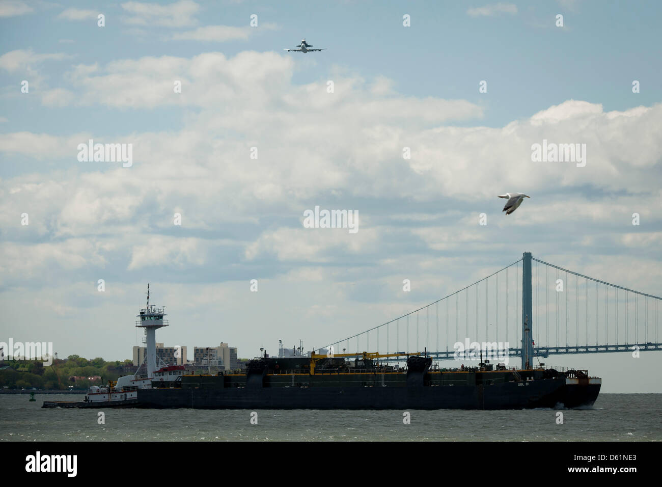 Space shuttle Enterprise, mounted atop a NASA 747 Shuttle Carrier Aircraft (SCA), is seen as it flies over the Verrazano Bridge, Friday, April 27, 2012, in New York. Enterprise was the first shuttle orbiter built for NASA performing test flights in the atmosphere and was incapable of spaceflight. Originally housed at the Smithsonian's Steven F. Udvar-Hazy Center, Enterprise will be Stock Photo