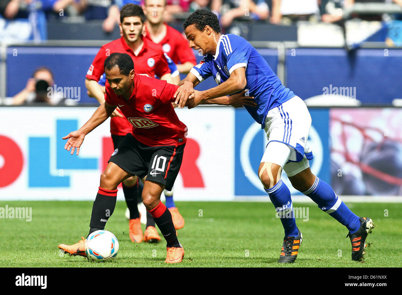 Berlin's Raffael vies for the ball with Schlake's Joel Matip during the Bundesliga soccer match between FC Schalke 04 and Hertha BSC at Veltins-Arena in Gelsenkirchen, Germany, 28 April 2012. Photo: KEVIN KUREK (ATTENTION: EMBARGO CONDITIONS! The DFL permits the further utilisation of the pictures in IPTV, mobile services and other new technologies only no earlier than two hours af Stock Photo