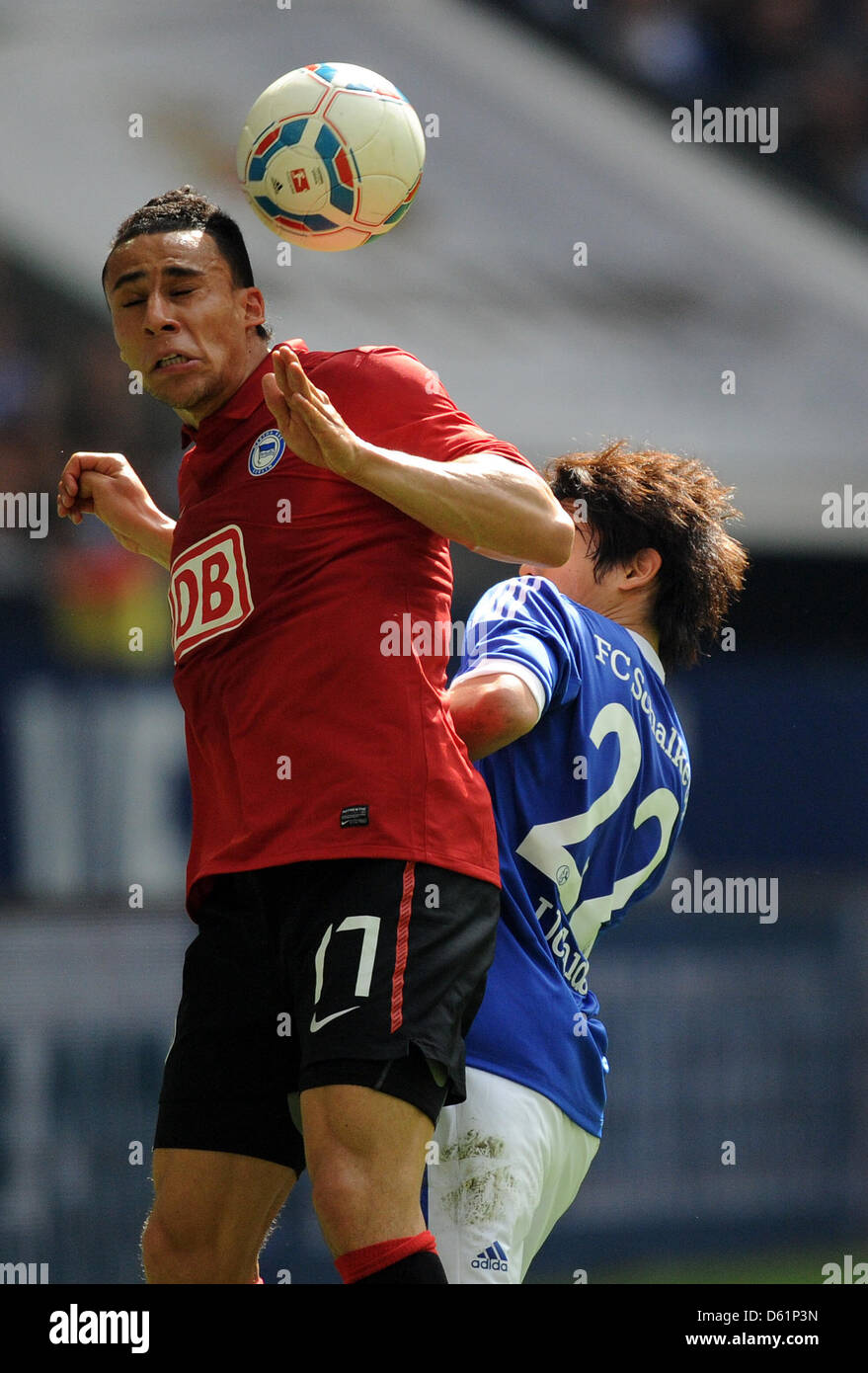 Schalke's  Atsuto Uchida (R) and Berlin's   Anis Ben-Hatira vie for the ball during the Bundesliga soccer match between  FC Schalke 04 and Hertha BSC at the Veltins-Arena in Gelsenkirchen, Germany, 28 April 2012. Photo: Caroline Seidel  (ATTENTION: EMBARGO CONDITIONS! The DFL permits the further utilisation of the pictures in IPTV, mobile services and other new technologies only no Stock Photo