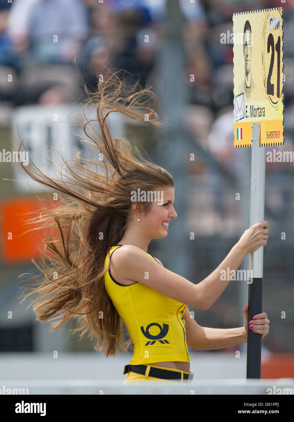 The wind blows up the hair of a grid girl during the first race of the German Touring Car Masters (DTM) at Hockenheimring in Hockenheim, Germany, 29 April 2012. Photo: UWE ANSPACH Stock Photo