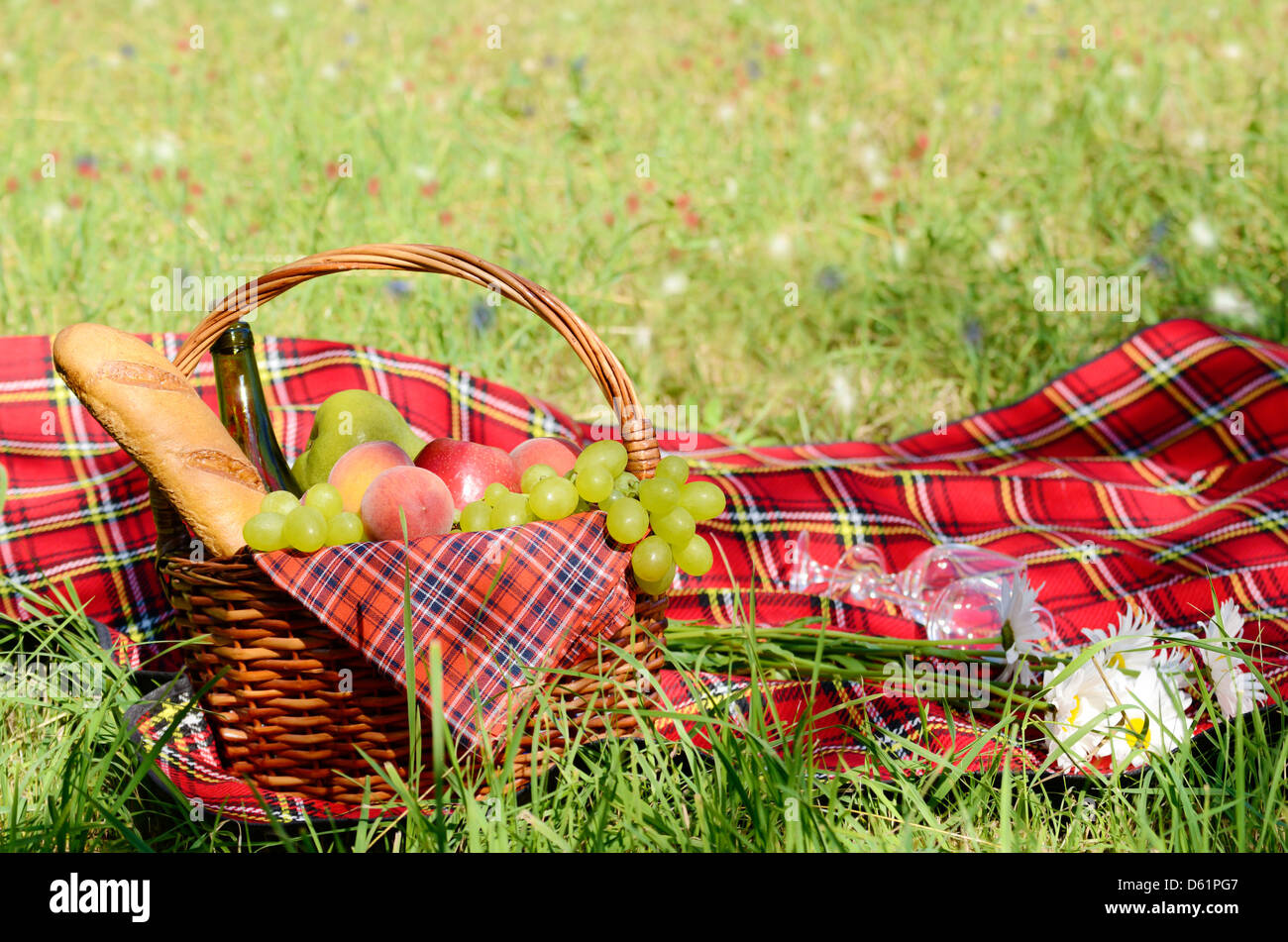 Picnic basket with red napkin fool of fruits, bread and wine Stock ...