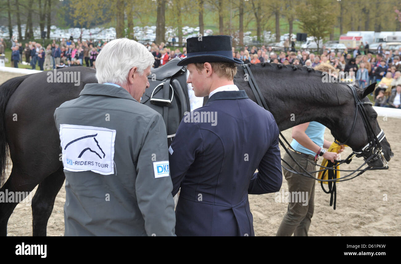 German dressage rider Matthias Alexander Rath (R) stands next to the