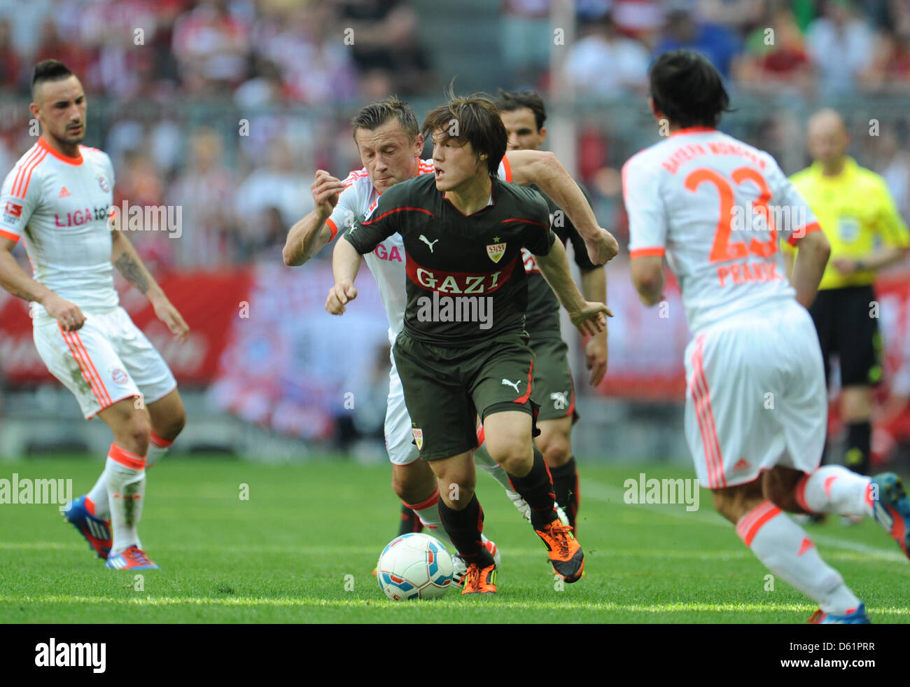 Bayern Munich's Ivica Olic (back, C, L) vies for the ball with Stuttgart's Gotoku Sakai (C, front) during the Bundesliga soccer match between FC Bayern Munich and  VfB Stuttgart at the Allianz Arena in Munich, Germany, 28 April 2012. Photo: Andreas Gebert Stock Photo