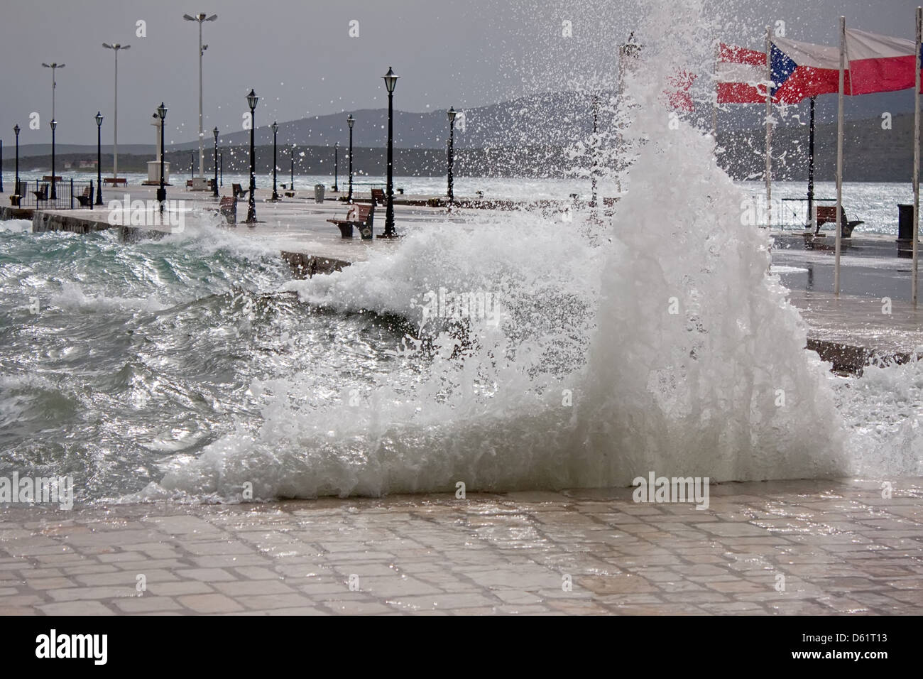 Waves crashing on the pier of the port of Itea, Greece Stock Photo