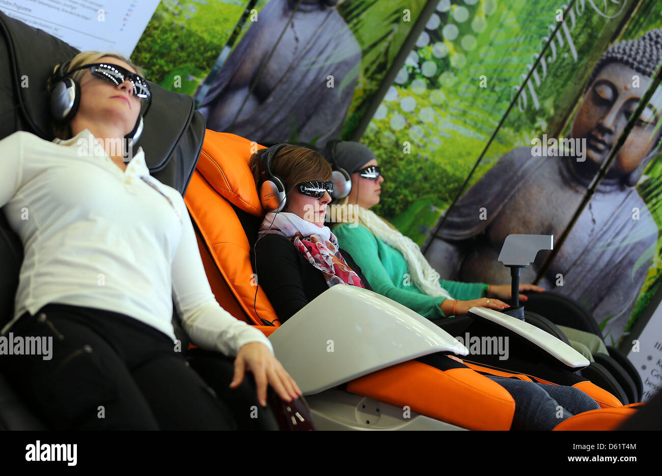 Cologne, Germany. 11th April 2013. Visitors sit in massage chairs at