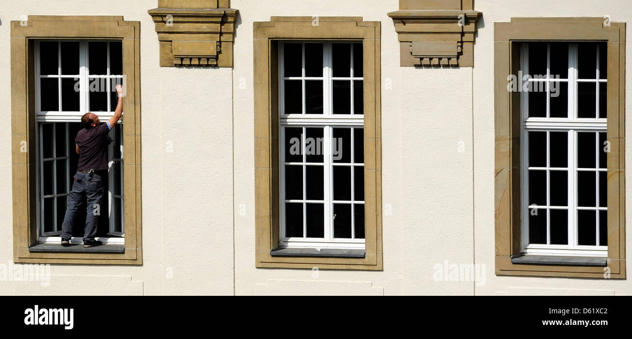Three window washers are cleaning the windows of the Higher Regional