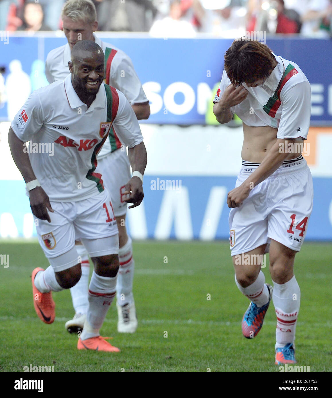 Augsburg's Nando Rafael (L) and goal scorer Ja-Cheol Koo celebrate the 1-0 goal during the Bundelsiga soccer match between FC Augsburg and Hamburger SV at SGL-Arena in Augsburg, Germany, 05 May 2012. Photo: STEFAN PUCHNER  (ATTENTION: EMBARGO CONDITIONS! The DFL permits the further utilisation of the pictures in IPTV, mobile services and other new technologies only no earlier than  Stock Photo