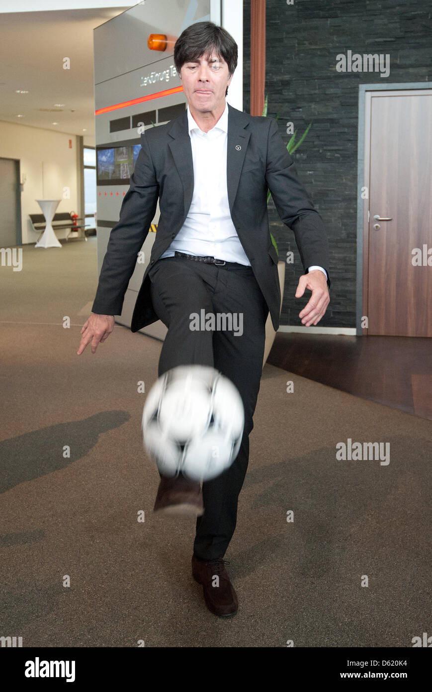 German national soccer coach Joachim Loew plays with a ball during the press conference on the notification of the provisional German European Championship squad in Rastatt, Germany, 07 May 2012. On 29 May Loew has to announce the official squad. Photo: UWE ANSPACH Stock Photo