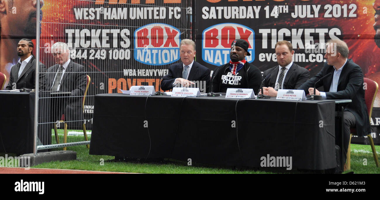 Suspended professional boxer Dereck Chisora (3-R) sits next to a fence next to boxer David Haye (L) during a press conference at West Ham United's Boleyn Ground in London, England, 08 May 2012. Chisora wants to fight his compatriat David Haye using a licence from Luxembourg. The fight for 14 July was cancelled on Thursday in London. Photo: INGA RADEL Stock Photo